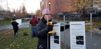 Gretchen Robinkin of Boston Society of Landscape Architects puts up the signs explaining the science behind the art. BSLA has been involved in the work from conception to implementation.